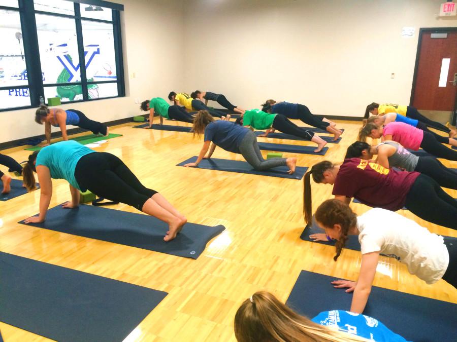Xavier yoga students practice their asanas. 