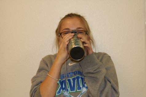 Junior Arden Schraff fuels up for the day with coffee.
