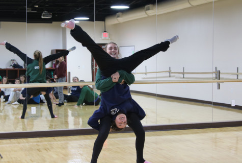 Juniors Gracie Dowd and Paige Price show off their athleticism while performing tricks in dance class.