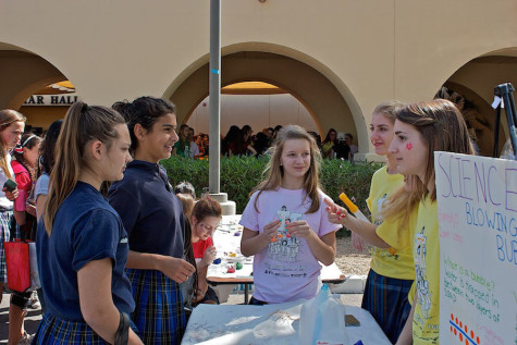 Xavier girls show 8th graders a science experiment.
