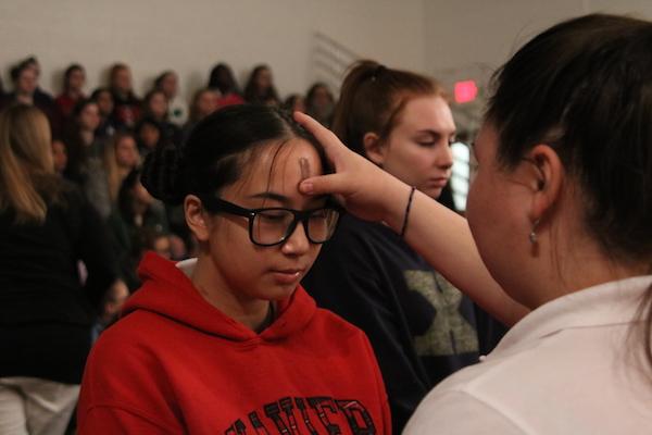 Amy Duong 17 receives ashes.
