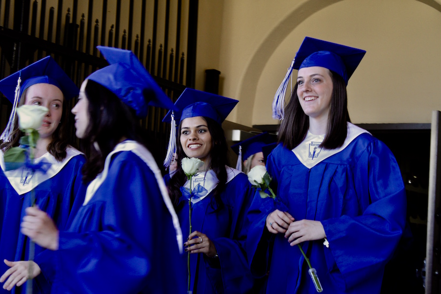Megan Murphy, Alex exiting the Robsom Gymnasium in their blue graduation garb and honor stoles on Sat. May 13, 2017. 