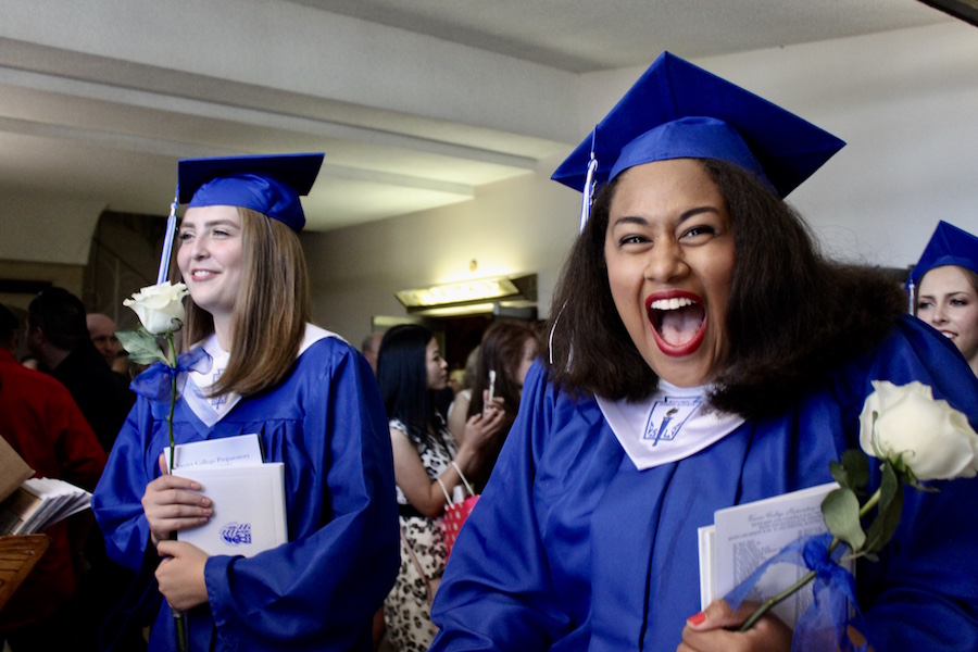 Maria White exclaims with excitement while exiting Xaviers seventy-first annual commencement ceremony at St. Francis Xavier Church on Sat., May 13, 2017.