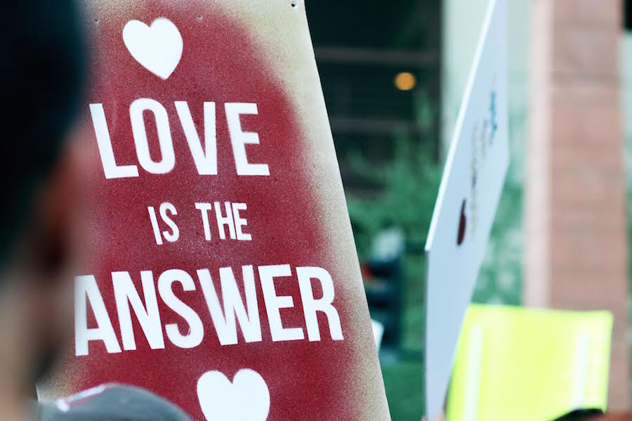A spray-painted poster reads Love is the answer. Protesters congregated outside the building where President Donald J. Trump held a campaign-style rally on Tuesday, Aug. 22, 2017.