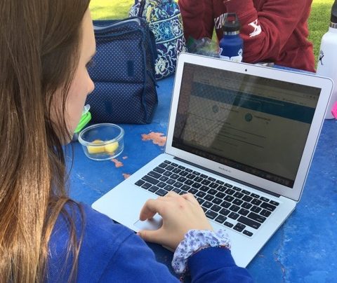 Jessica Roy '18 studies at a picnic table by the tennis courts at Xavier College Preparatory. Roy studies throughout the days leading up to a major test. 