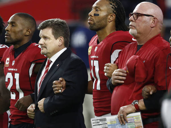 From left; Arizona Cardinals cornerback Patrick Peterson, president Michael Bidwill, wide receiver Larry Fitzgerald and head coach Bruce Arians stand during the national anthem prior to an NFL football game against the Dallas Cowboys.