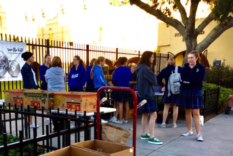 Xavier students donating canned goods and money for the annual food drive at Xavier College Prep on Thursday, Nov. 9, 2017.