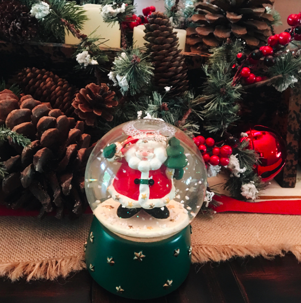 +A+cheerful%2C+Santa+snow-globe%2C+festive+jingle+bells+and+pine-cones