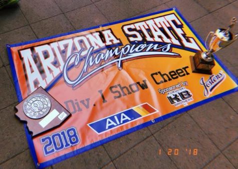 Cheer's state championship trophy and banner alongside pom's runner up award