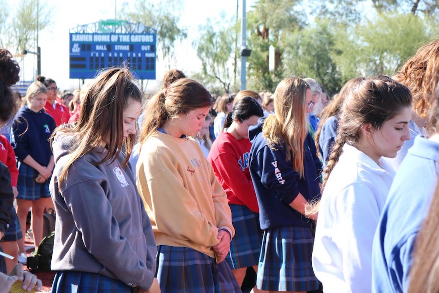 Xavier students bow their heads during 17 seconds of silences in honor of the 17 victims of gun violence who were killed at Marjory Stoneman Douglas High School on February 14.