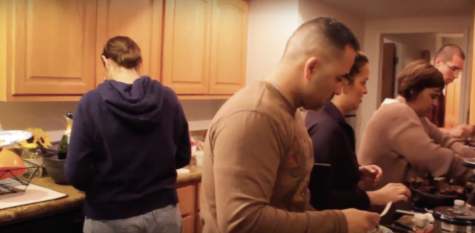 A family spending time together during Thanksgiving. The whole family is in charge of preparing their own dish.