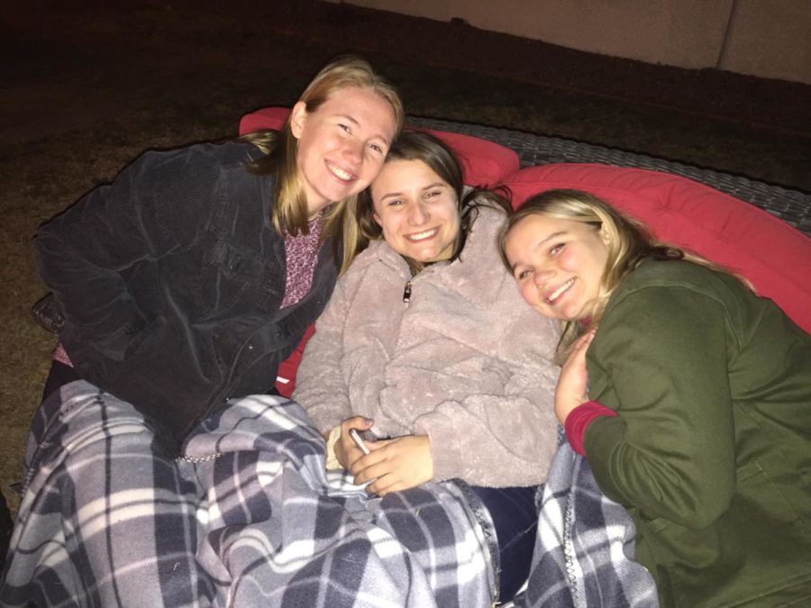 Seniors Maddie Wickers, Clare Carlsonn, and Abbey Alexander snuggle up for a movie night.