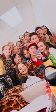 Cast members huddle up to take a mirror selfie backstage before their matinee show.
