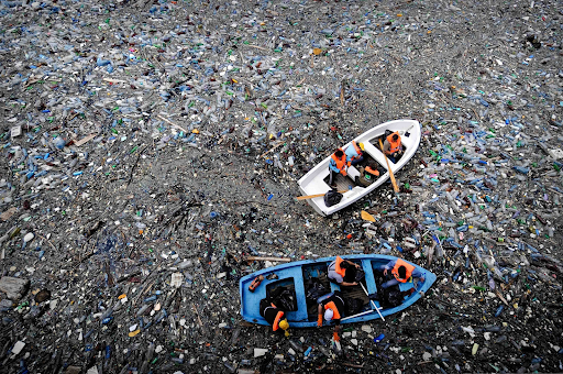 Picture showing volunteers trying to clear a dam containing plastic bottles and other garbage, near the town of Krichim, Bulgaria. 
