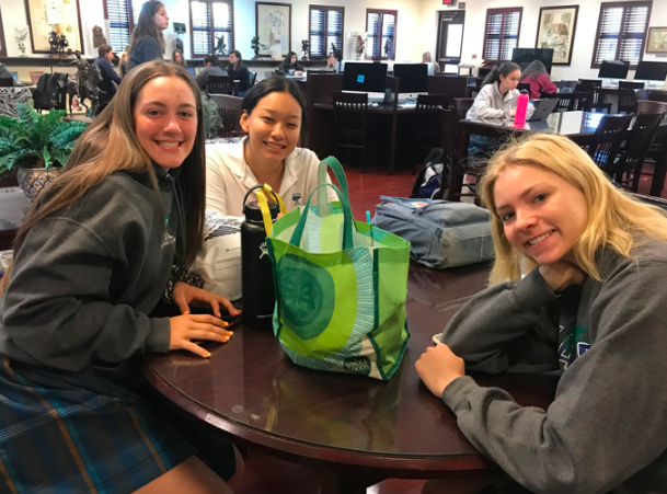 Sophomores Meghan Shouten, Sharon Cardenas, and Nina McFarland wait in the library until their shadows get dropped off. 
Photo credit: Caroline Hink '20.