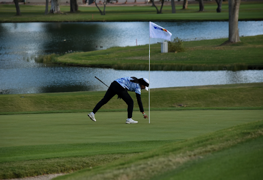 Junior Ivy Song retrieves her ball at the championship on the 18th hole. 
