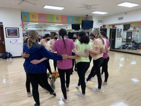 Xavier’s Performance Dancers motivate each other as they get ready to perform at the Traditions Day assembly.