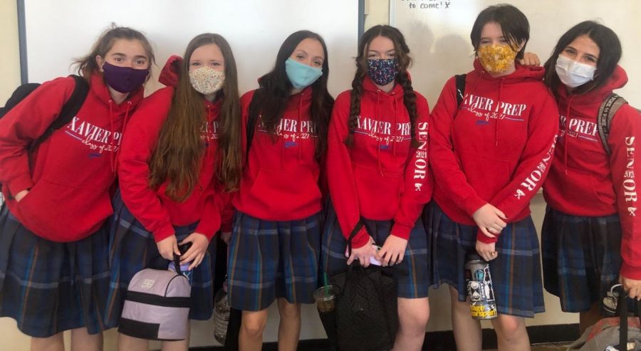 Xavier seniors pose in AP English Literature and Composition with their signature red sweatshirts as they prepare to head to their next class.