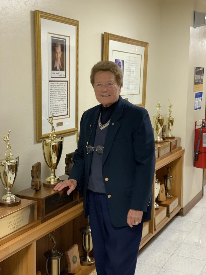 Sister Lynn Winsor, who will soon be inducted into the National Interscholastic Athletic Administration Hall of Fame, poses in a hall of trophies by Xavier's athletic offices.