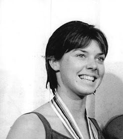 Jeanne Collier, who graduated from Xavier College Prep in 1964, poses with her silver medal for diving after the Tokyo Olympics medal ceremony in 1964.