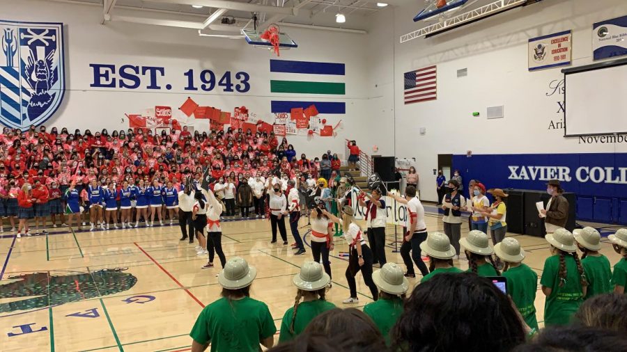 The+Xavier+faculty+triumphantly+dominates+the+court+with+their+%E2%80%9CPirates+of+the+Caribbean%E2%80%9D+themed+dance.+In+participating%2C+the+faculty+not+only+joined+the+fun%2C+but+allowed+the+students+to+get+to+know+them+through+their+enthusiasm+and+school+spirit.+