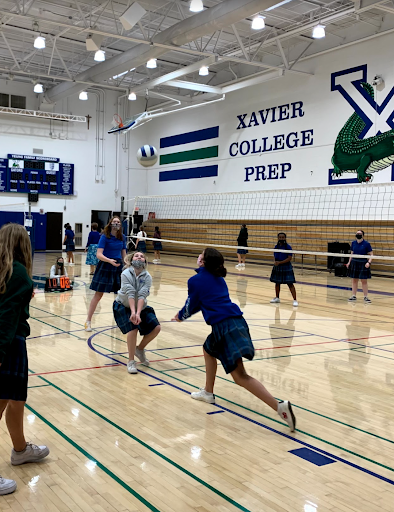 On court 1 in the Activities Center, Sally Ann Martinez’s homeroom team plays against Barb Chura’s homeroom during Frosh Intramurals Week. Chura’s “Pink Rangers” won 21-18 against Martinez’s “God Squad.”