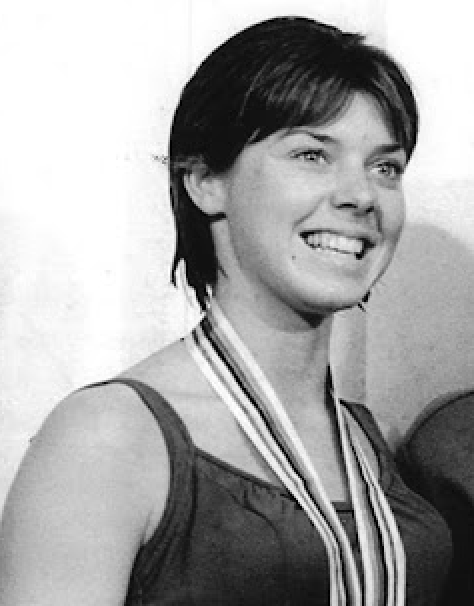Jeanne Collier, who graduated from Xavier College Prep in 1964, poses with her silver medal for diving after the Tokyo Olympics medal ceremony in 1964.