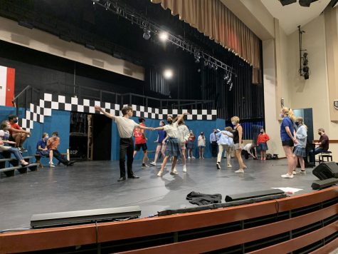 Xavier and Brophy actors take the stage as they rehearse for the dance number in the upcoming scene. A commitment to long rehearsal hours from the cast and crew is essential for a successful opening night. 