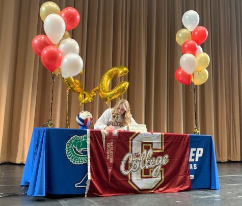 Isabella Sinacori signs a national letter of intent to play volleyball at the College of Charleston on the morning of Wednesday, November 10, at Xavier College Prep’s signing ceremony. Twelve other girls from Xavier also signed national letters of intent on this day.
