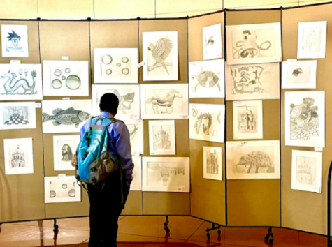 A guest at the 2021 Brophy College Preparatory Fine Arts Extravaganza admires the artwork on display created by students in their fine art electives.