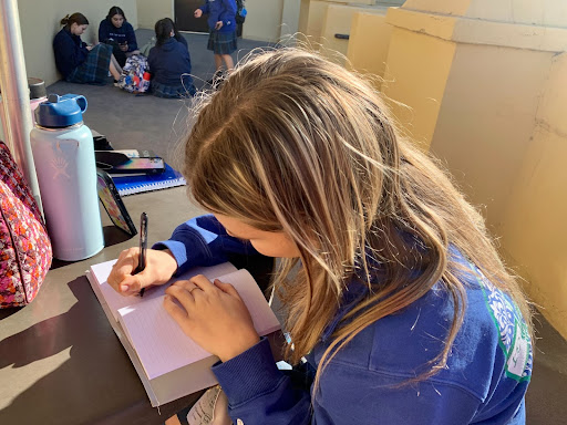 Senior Maggie Moore takes time to journal during her break in between classes. By journaling, she is able to reflect upon her personal goals and find gratitude for the day ahead. 