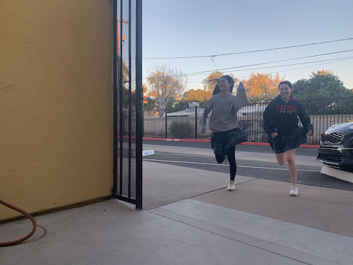 Students Asiana Guang and Gianna Bucci enact a morning scene by Fitzgerald Hall. Gators-turned-sprinters rush into homeroom before the 7:45 a.m. bell knowing that they will make it to their seats with a few seconds to spare.