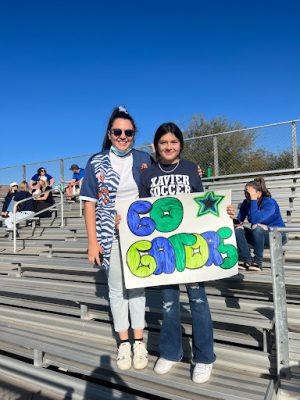 On February 12 at the Queen Creek soccer field, members of the JV-B soccer team Angie Galvan ‘25 and Jackie Galvan ‘23 support the varsity soccer team. Xavier won 1-0.