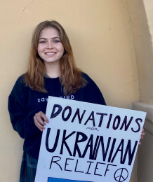 Eleanor Halaby ‘24 poses with her Ukraine fundraiser poster. She along with Tess Morrison raised $2300. (Photo courtesy of Sister Lynn Winsor)