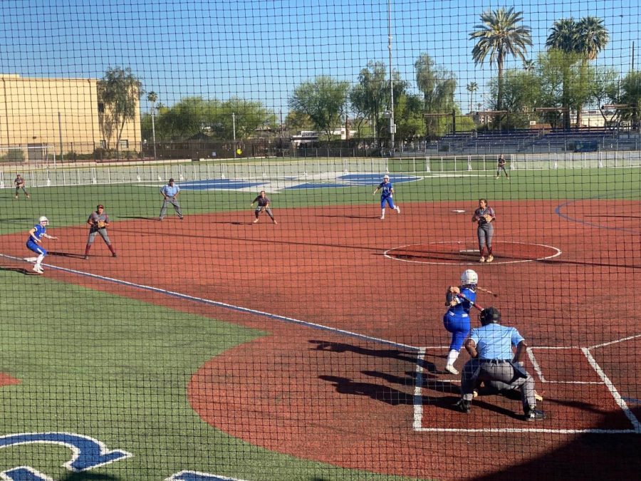 A+Xavier+batter+swings+to+launch+the+incoming+softball+in+a+game+against+Red+Mountain.+The+game+concluded+with+paying+tribute+to+senior+pitcher+Riley+Flynn+for+her+500th+strikeout.+