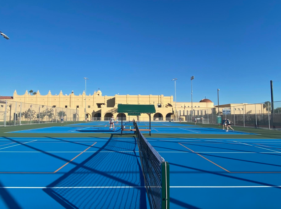 A+student+gives+the+new+tennis+courts+a+trial+run.+The+courts+were+remodeled+this+past+year.