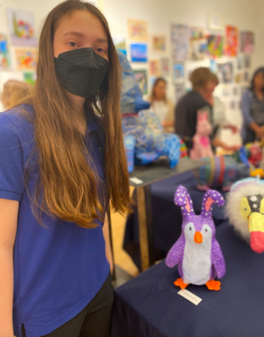 Claire Zangerle ‘22 presents a penguin statue at the art show. As a senior at Xavier, she took Sculpture, in which she created the above statue.