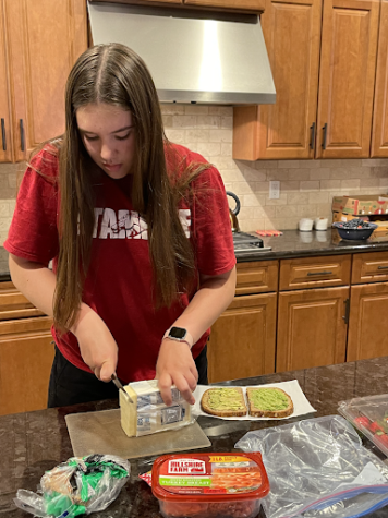 Junior Evelynn Papez prepares her lunch for the next day of school, continuing her Lenten promise of staying healthy by making her own lunches. 