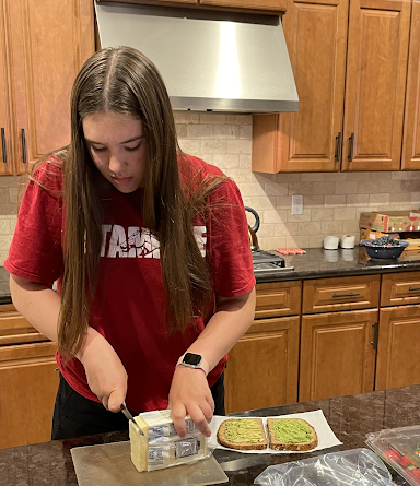 Junior Evelynn Papez prepares her lunch for the next day of school, continuing her Lenten promise of staying healthy by making her own lunches. 