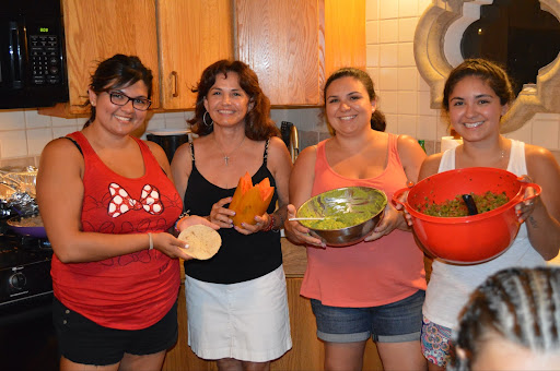 Alexis Quintero (far right) prepares food along with her two sisters and mother. In 2020, she missed her family’s yearly trip to Mexico for the first time.