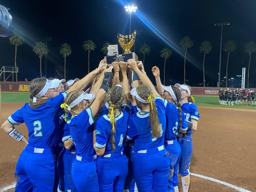 Xavier’s varsity softball team holds up its state championship trophy in celebration after winning the championship against Hamilton 13-0.  That was the fourth win of the season against the Huskies, sweeping them.
