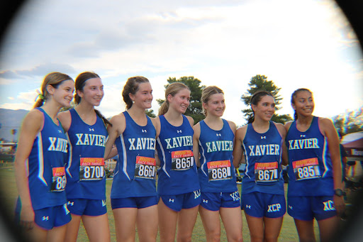 Varsity runners Nora Hinkle, Julia Russo, Reese Brown, Lily Beaver, Kylie Graf, Bella Gomez and Emily Manuelito pose after their race at the John Gleeson Invitational in Tucson. The team finished with 36 points, easily defeating second place finisher Salpointe Catholic with 60 points. 