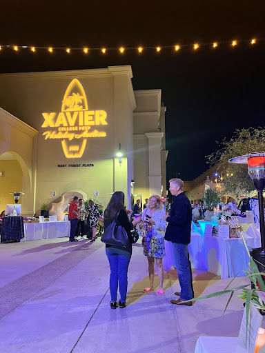 Xavier families, friends and guests gather outside in the Hart Family Plaza for the holiday auction. Guests bid on gift baskets and other items as the live 
auction begins. 