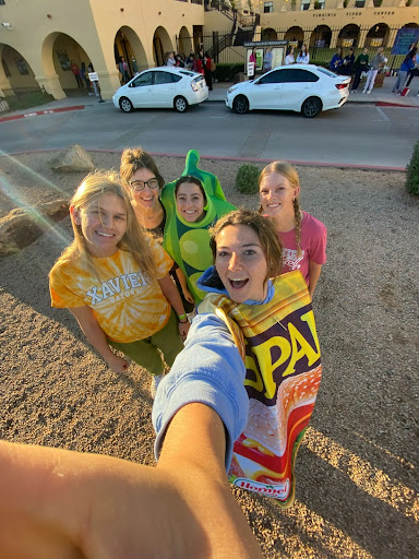 Xavier’s 2022-2023 NHS leadership (from left to right: Neva Nemanic ‘24, Brynn Murphy ‘23,  Gianna Bucci ‘24, Bella Leonard ‘23, Annie Dawson ‘23) awaits students bringing cans and donations to the morning collections. The Xavier canned food drive has become more impactful and more involved through the years.