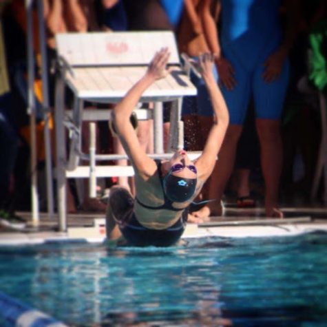 Genevieve George dives into the water at the 2019 state finals. Her performance in the Girls 100 Backstroke earned her 2nd place.