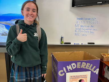 Sophomore Presley Kaiser stands in Key Club moderator Alison Mead’s classroom that houses one of The Cinderella Affair boxes. Kaiser drives the boxes both to and from Xavier and to their final destination, The Cinderella Castle.