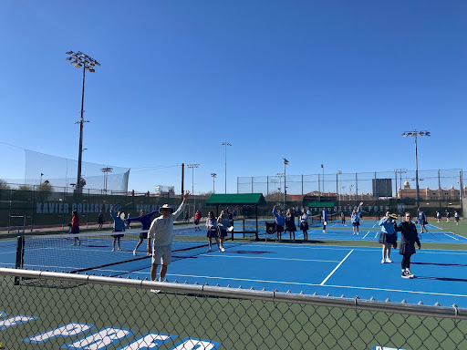 Coach Karl Behring welcomes the usual lunchtime crew as girls gather on the courts to play games of pickleball. They meet once a week on Wednesdays to pick up rackets with friends. 