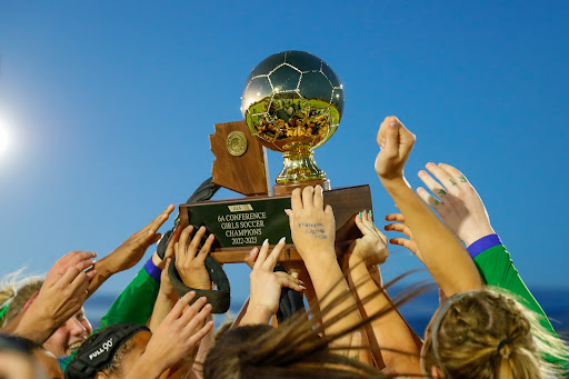 Xavier’s varsity soccer team holds up the first-place trophy after winning its third consecutive 6A State Championship. None of this could have been done without the support of teammates,  coaches, students and Xavier’s overall community. 