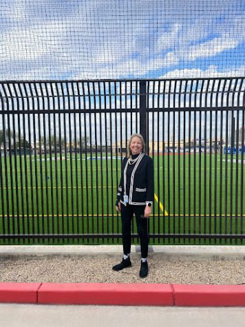 Lisa Zuba stands outside her office along the gated confines of Xavier’s soccer field. Zuba has transcended all confinements by the experiences she has encountered. 