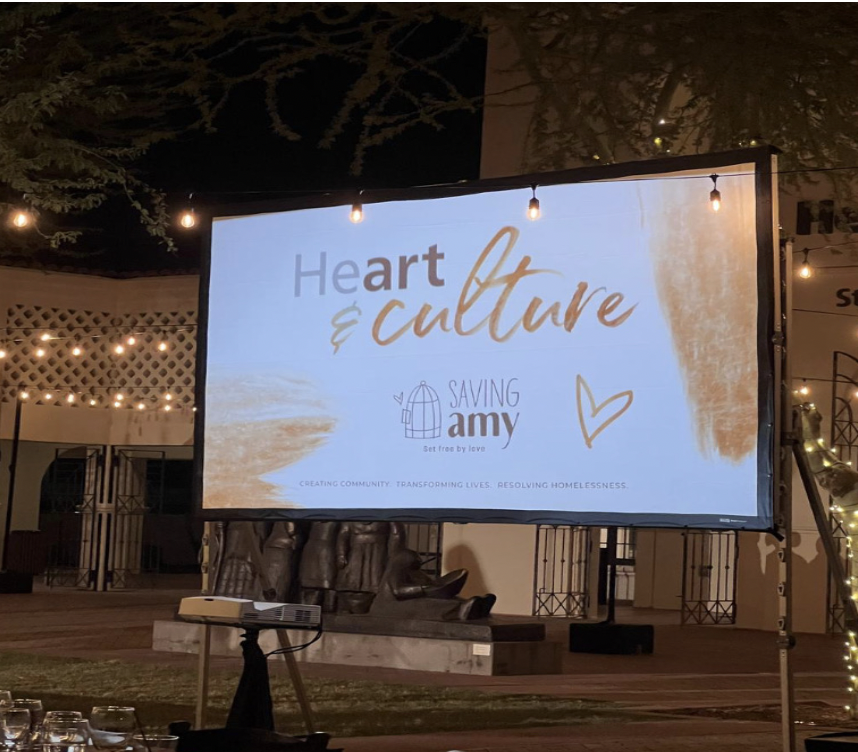 A+projector+screen+with+Saving+Amys+logo+and+catchphrase+is+depicted+at+a+gala+event+held+by+the+non-profit+organization.+This+event+celebrated+the+impact+Saving+Amy+has+made+on+resolving+homelessness+through+mentoring%2C+teaching+and+transforming+lives.+